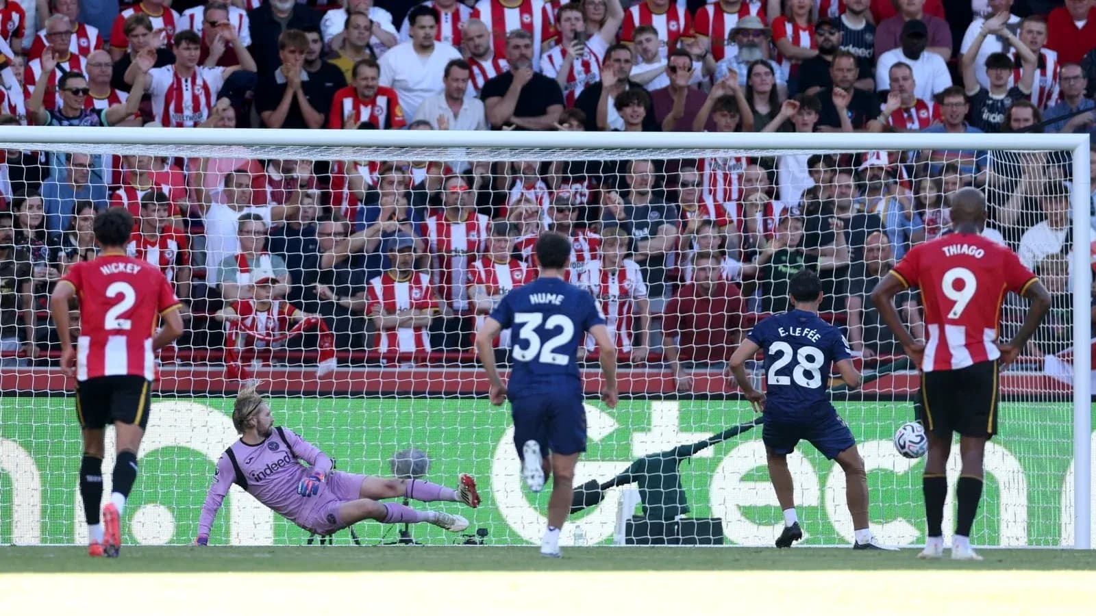 Player taking penalty kick with goalkeeper diving Player taking penalty kick with goalkeeper diving