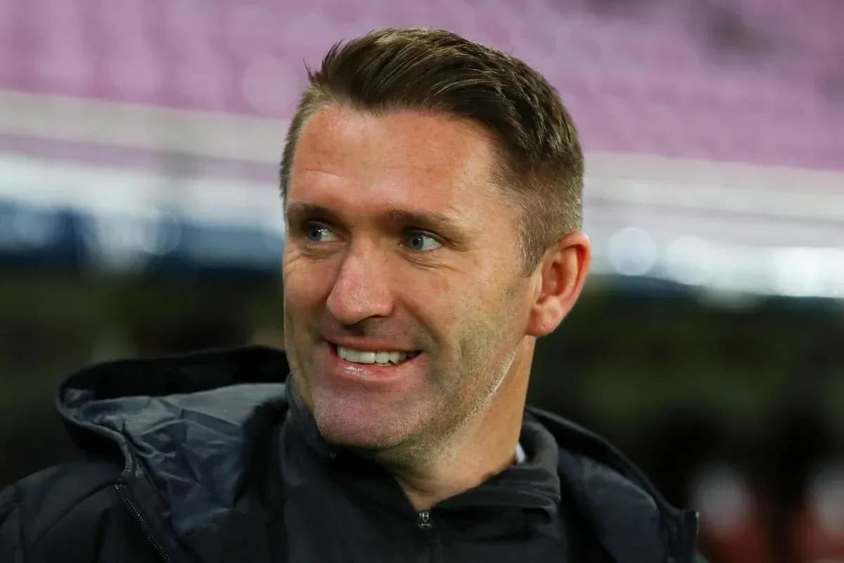 Coach smiling on the sidelines during a match Coach smiling on the sidelines during a match