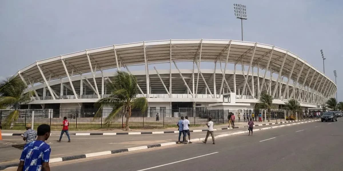 Exterior view of a modern stadium with pedestrians Exterior view of a modern stadium with pedestrians