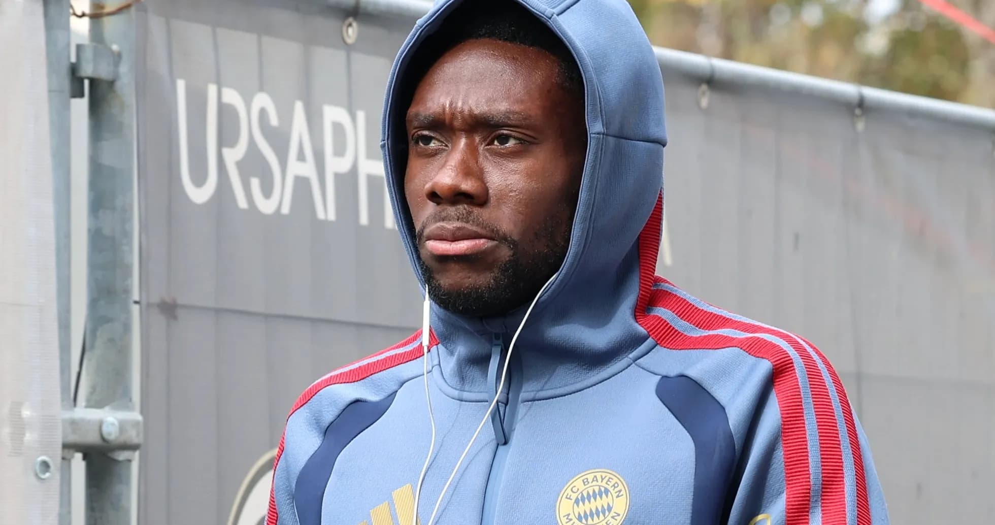Player wearing Bayern Munich hoodie, walking with headphones Player wearing Bayern Munich hoodie, walking with headphones
