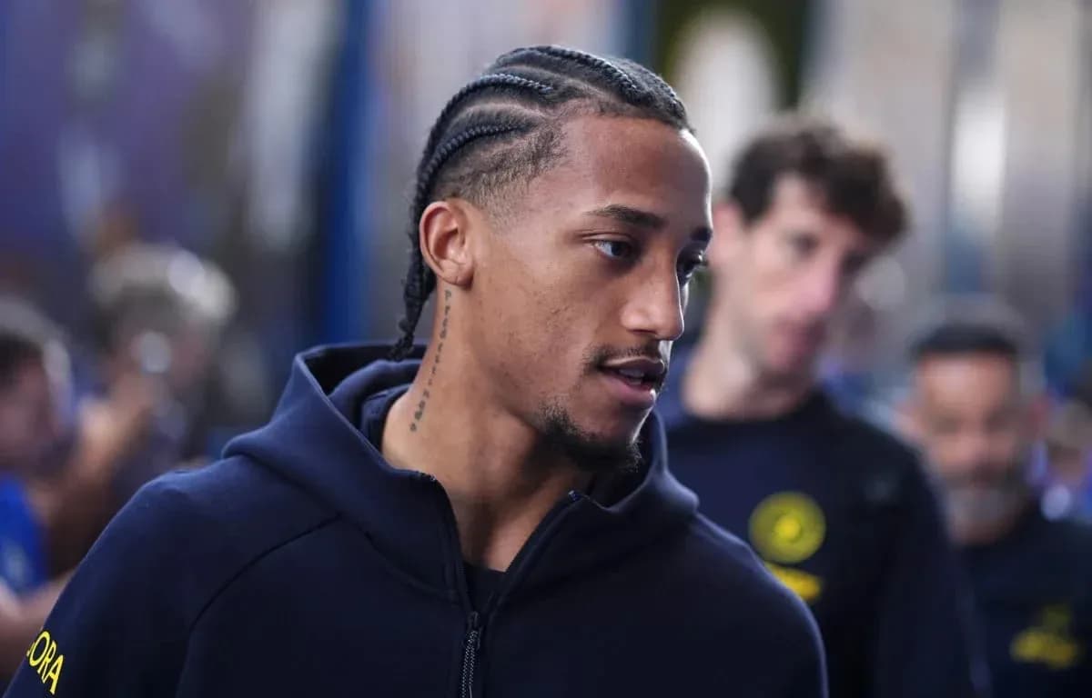 Player with braids walking in team attire Player with braids walking in team attire