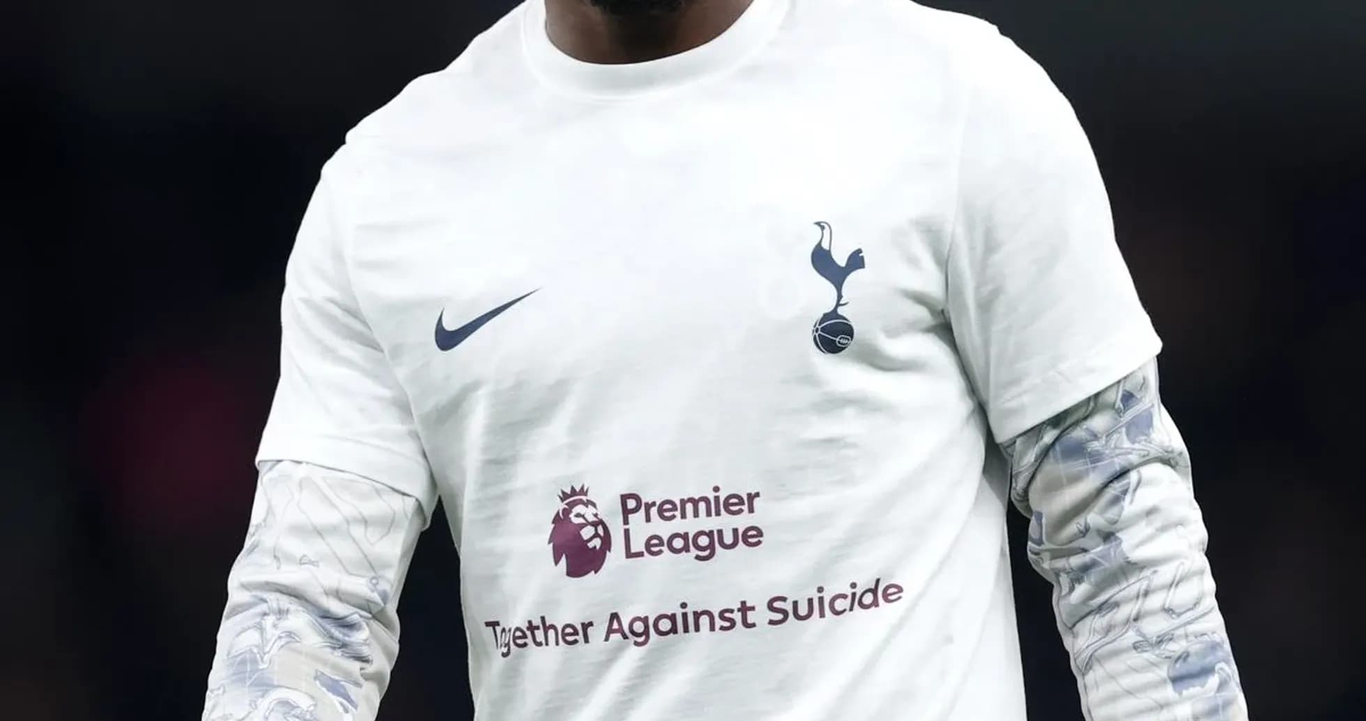 Player walking on pitch in Tottenham warm-up shirt Player walking on pitch in Tottenham warm-up shirt