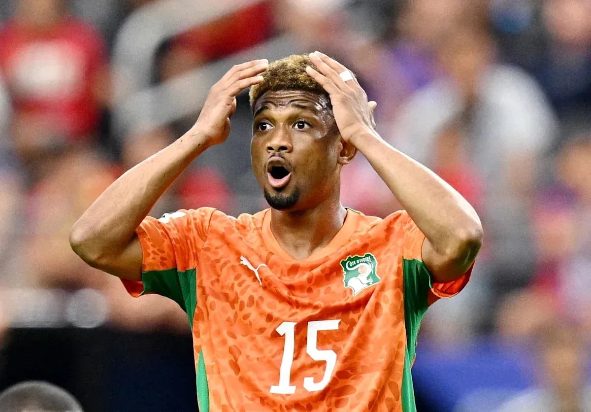 Player in orange jersey reacting during a match Player in orange jersey reacting during a match