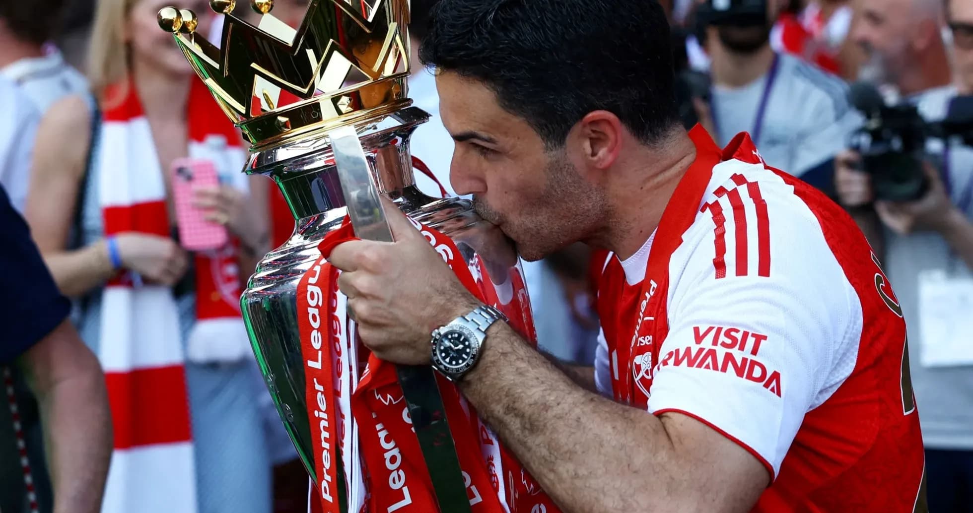 Manager kissing Premier League trophy during celebration Manager kissing Premier League trophy during celebration