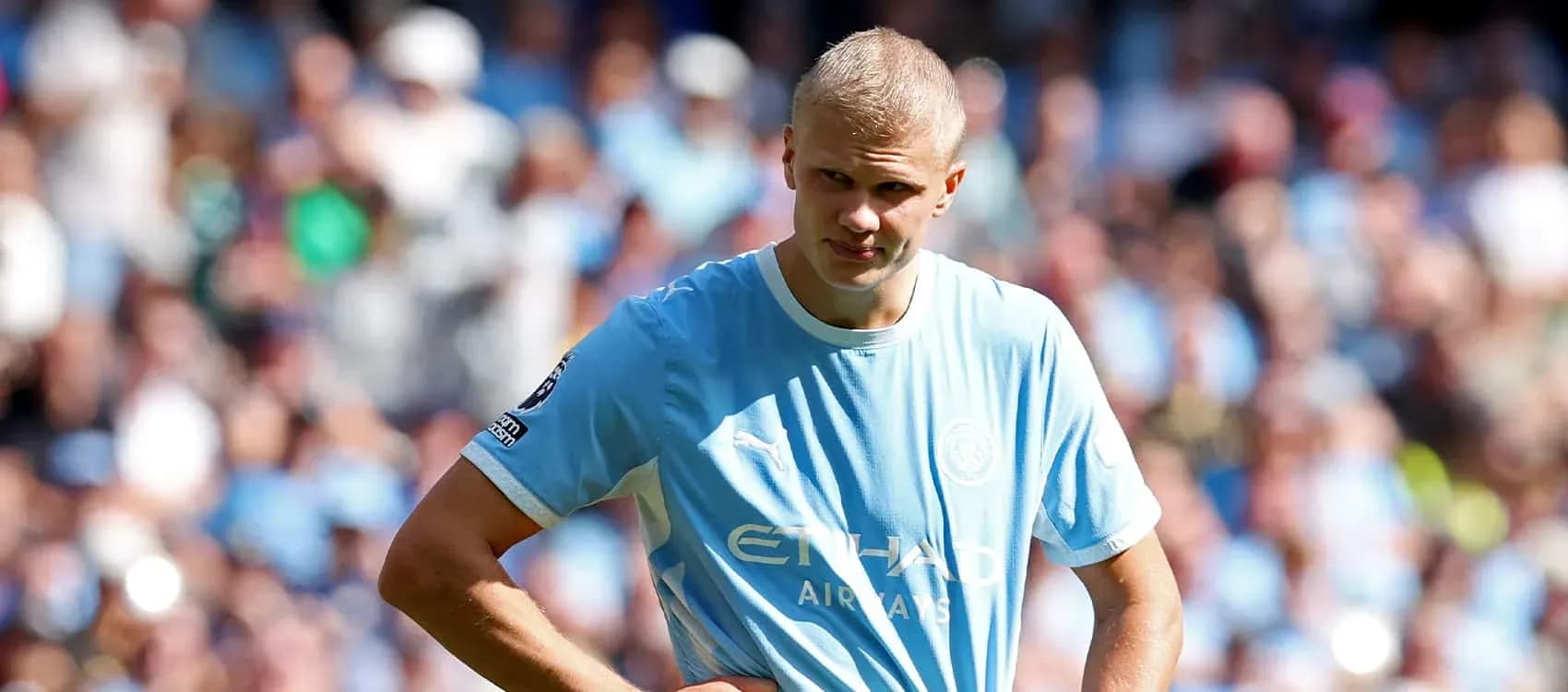 Player in light blue jersey on the pitch Player in light blue jersey on the pitch