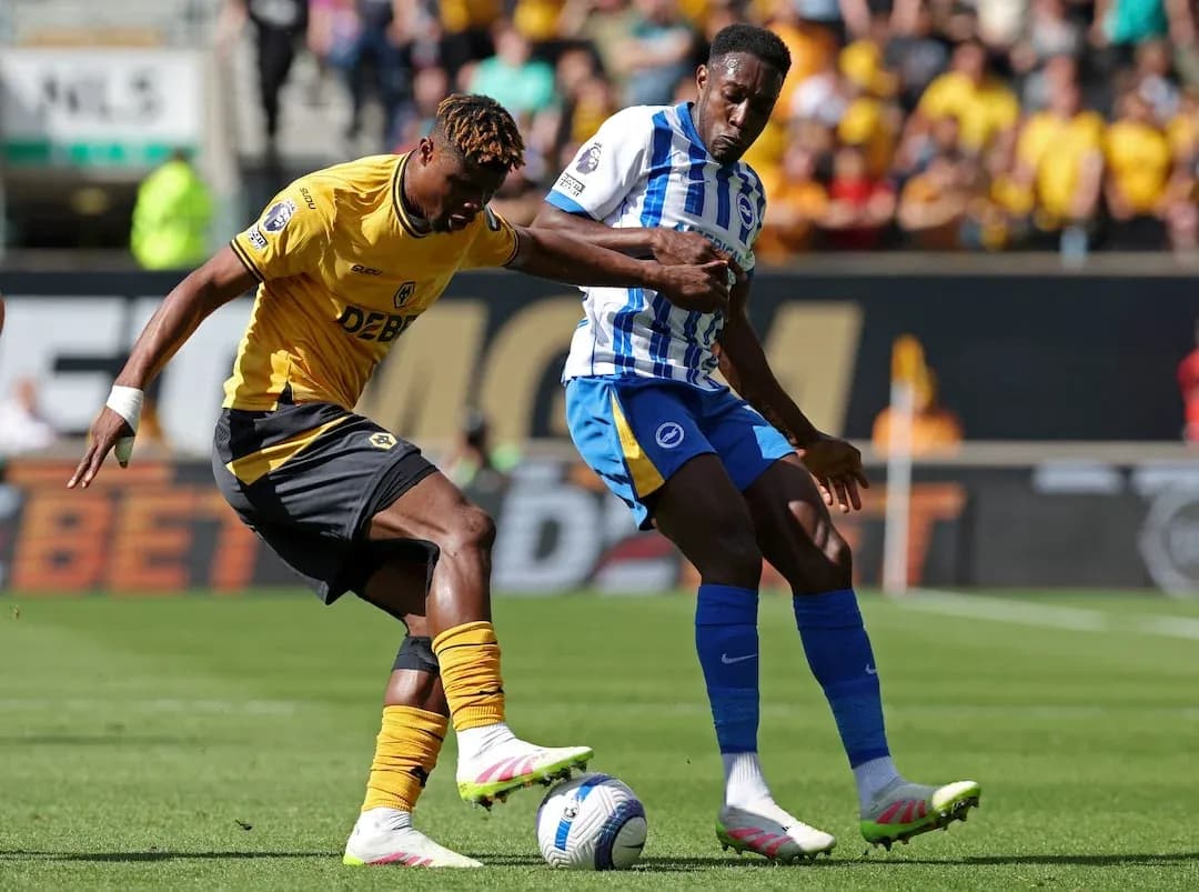 Brighton player challenging Wolves player for the ball Brighton player challenging Wolves player for the ball