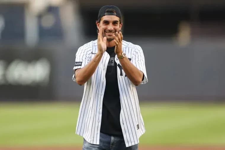 Man in Yankees jersey clapping at baseball field Man in Yankees jersey clapping at baseball field