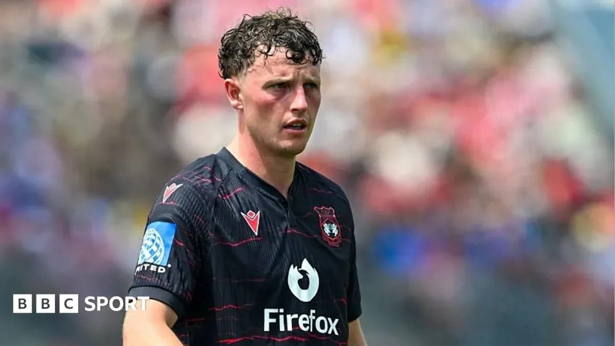 Player in black jersey during match on field Player in black jersey during match on field