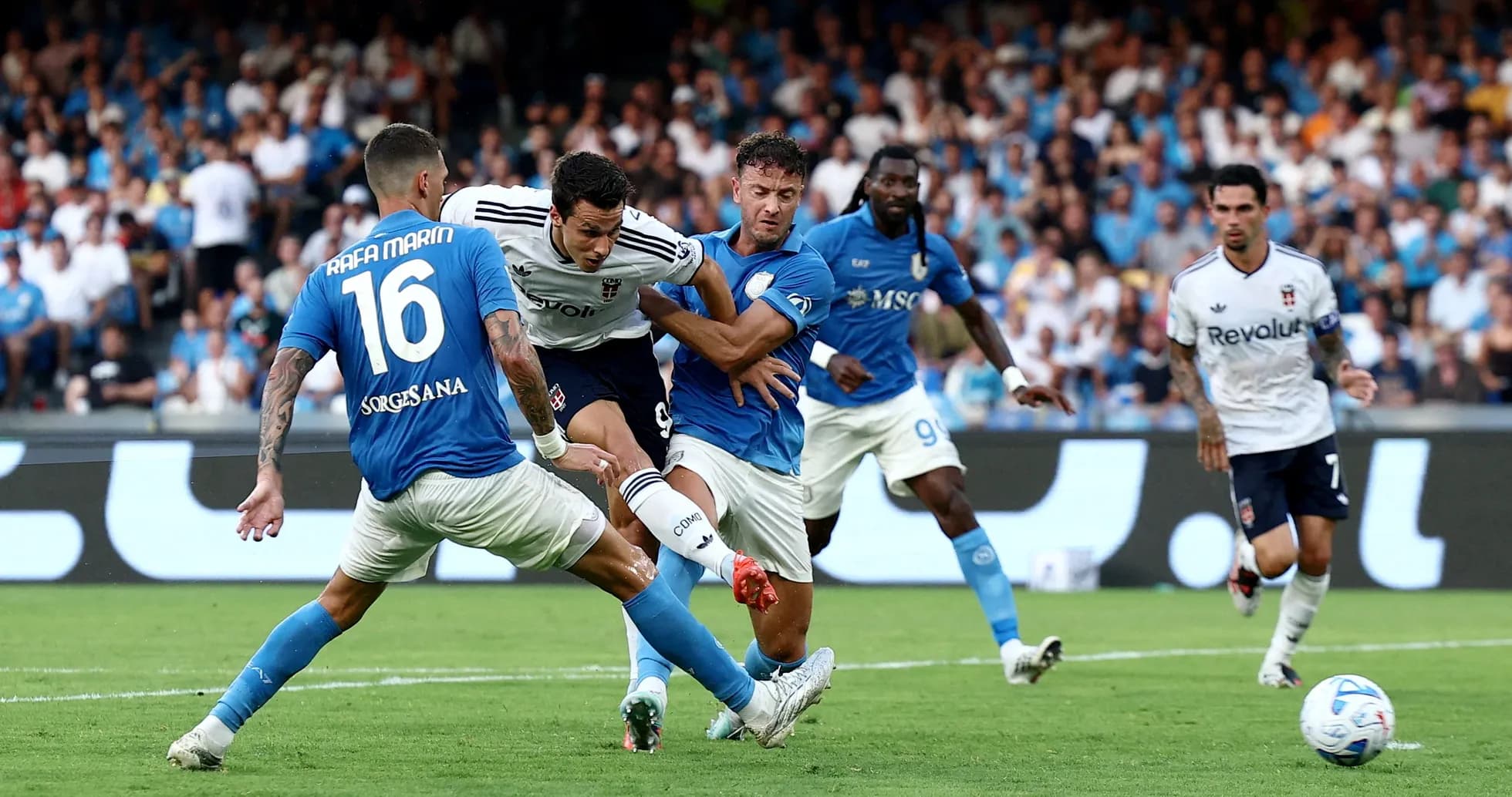 Napoli players challenging Como striker during match Napoli players challenging Como striker during match