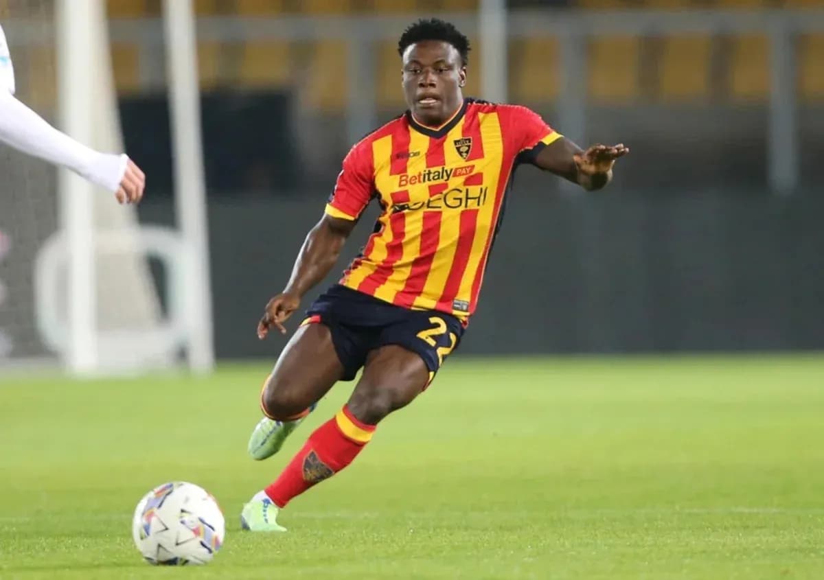 Player in red and yellow jersey dribbling ball Player in red and yellow jersey dribbling ball