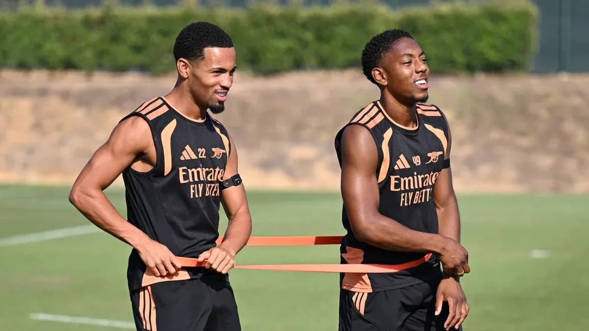 Two players training with resistance bands on field Two players training with resistance bands on field