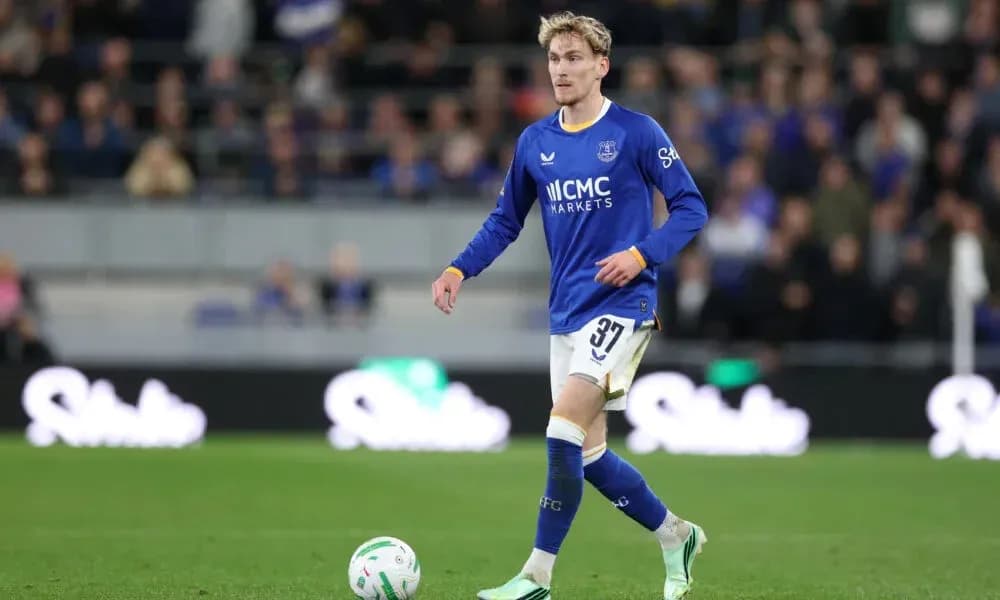 Player in blue kit walking on football pitch Player in blue kit walking on football pitch