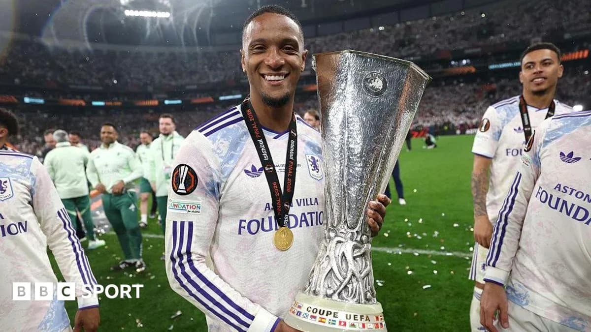 Player celebrating with UEFA trophy after victory Player celebrating with UEFA trophy after victory