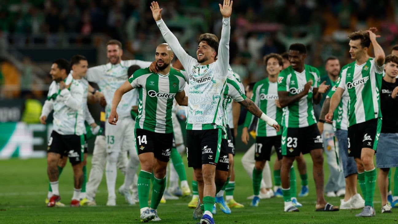 Real Betis players celebrating victory on the field Real Betis players celebrating victory on the field