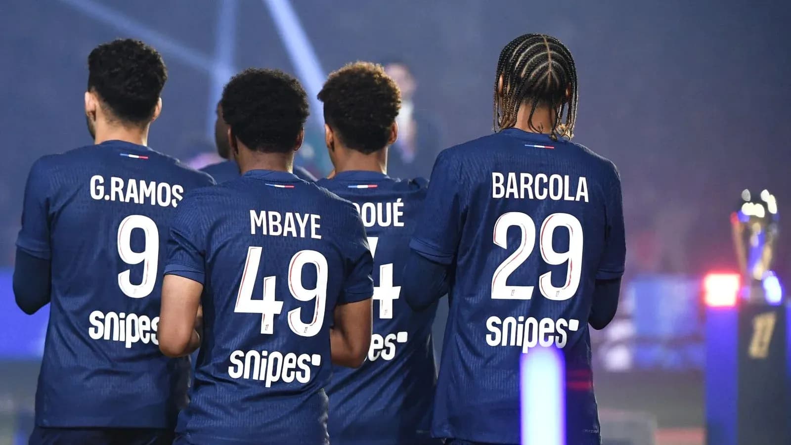 Four players in jerseys with names and numbers visible Four players in jerseys with names and numbers visible