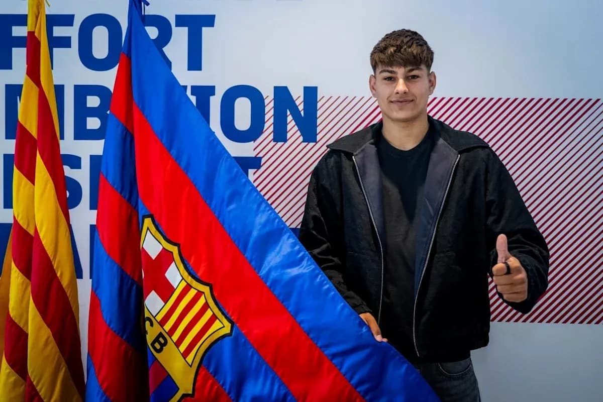 Player holding FC Barcelona flag at announcement event Player holding FC Barcelona flag at announcement event