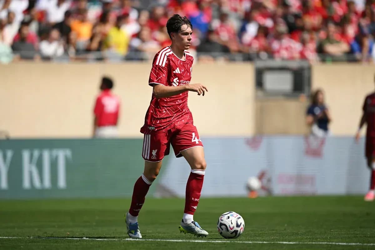 Liverpool player in red kit on the field Liverpool player in red kit on the field