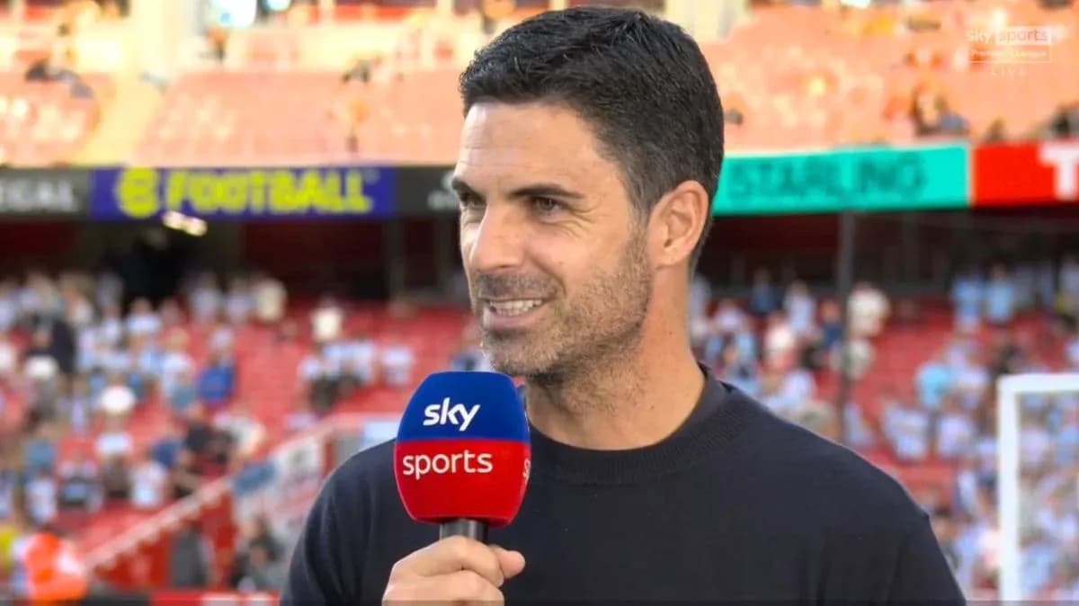 Coach speaking during pre-match interview on field Coach speaking during pre-match interview on field