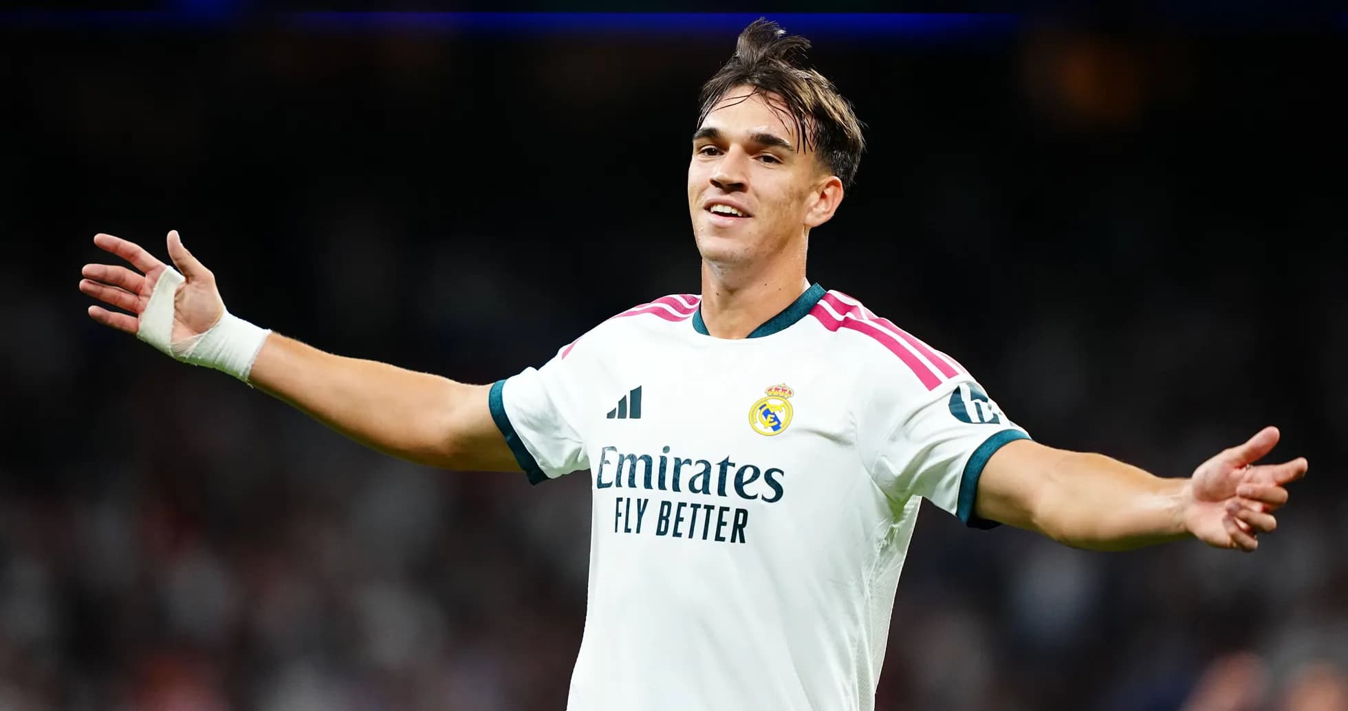 Player celebrating in Real Madrid jersey on field Player celebrating in Real Madrid jersey on field