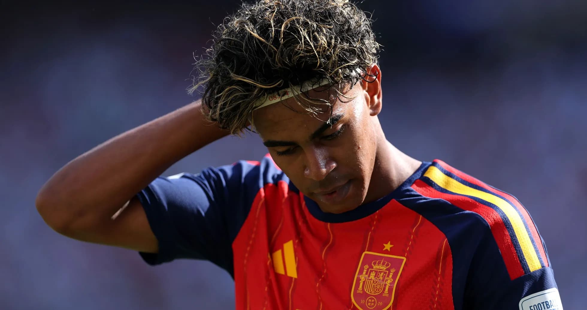 Player in Spain jersey looking down on the field Player in Spain jersey looking down on the field