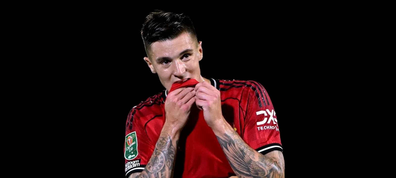 Player biting his jersey during match celebration Player biting his jersey during match celebration