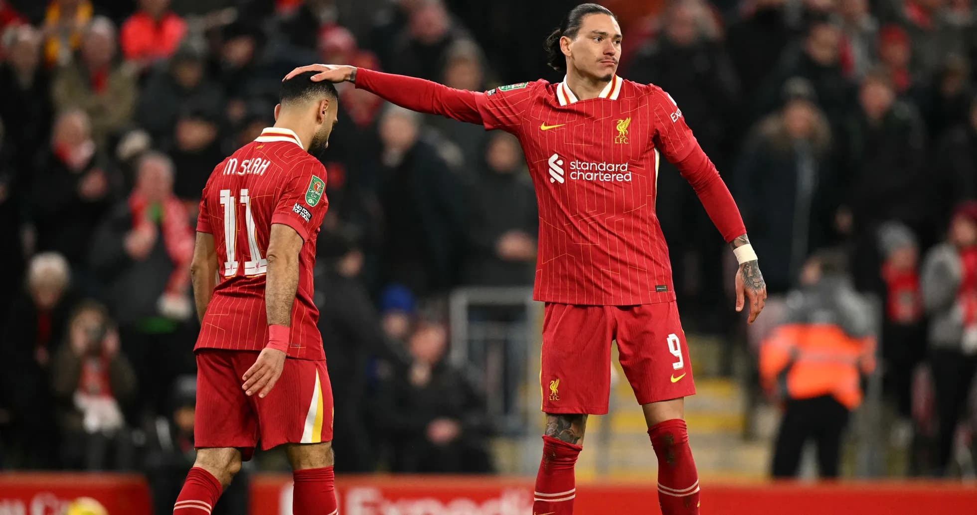 Two Liverpool players interacting on the pitch Two Liverpool players interacting on the pitch