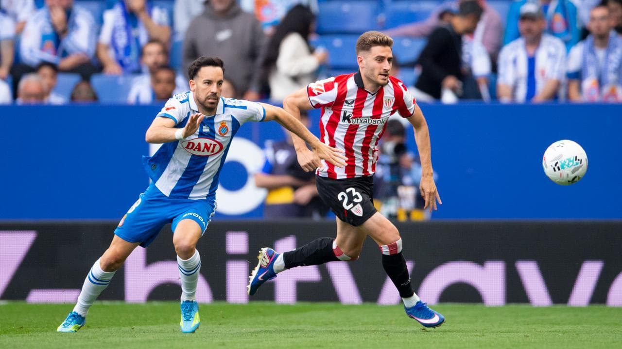 Espanyol player chasing Athletic Club forward Espanyol player chasing Athletic Club forward