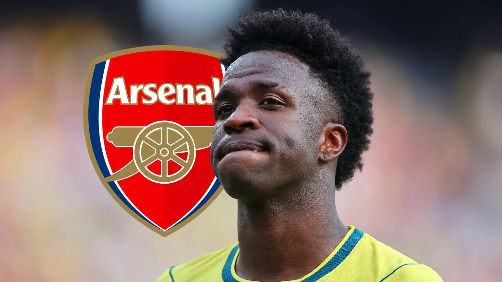 Player standing in front of Arsenal logo Player standing in front of Arsenal logo