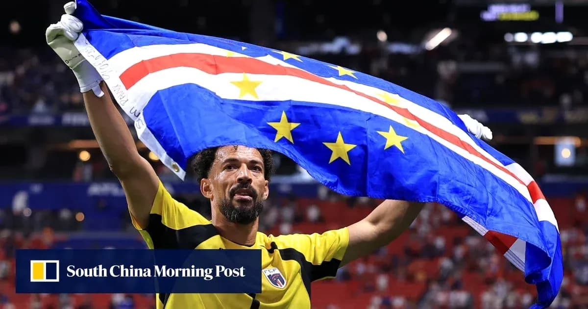 Player celebrating with Cape Verde flag in stadium Player celebrating with Cape Verde flag in stadium