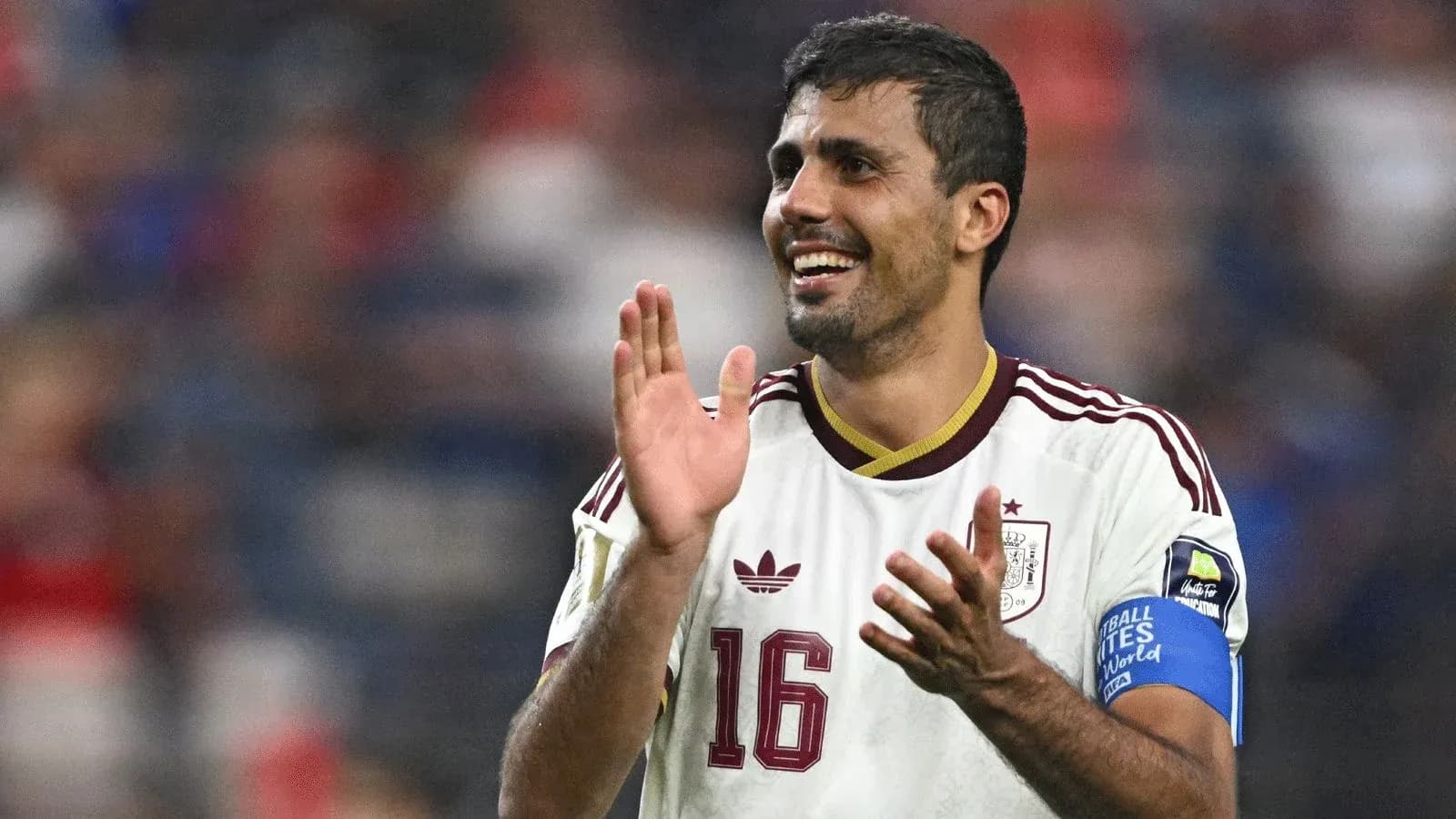 Player applauding while wearing Spain national team jersey Player applauding while wearing Spain national team jersey