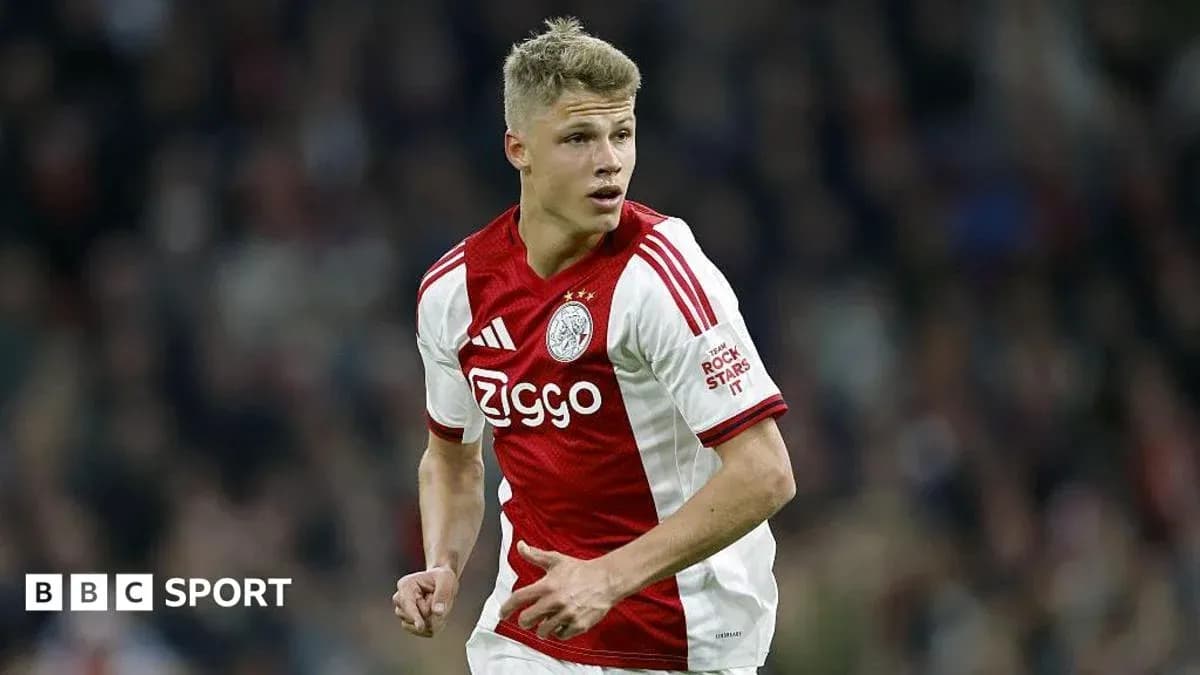 Player in Ajax kit during match action Player in Ajax kit during match action