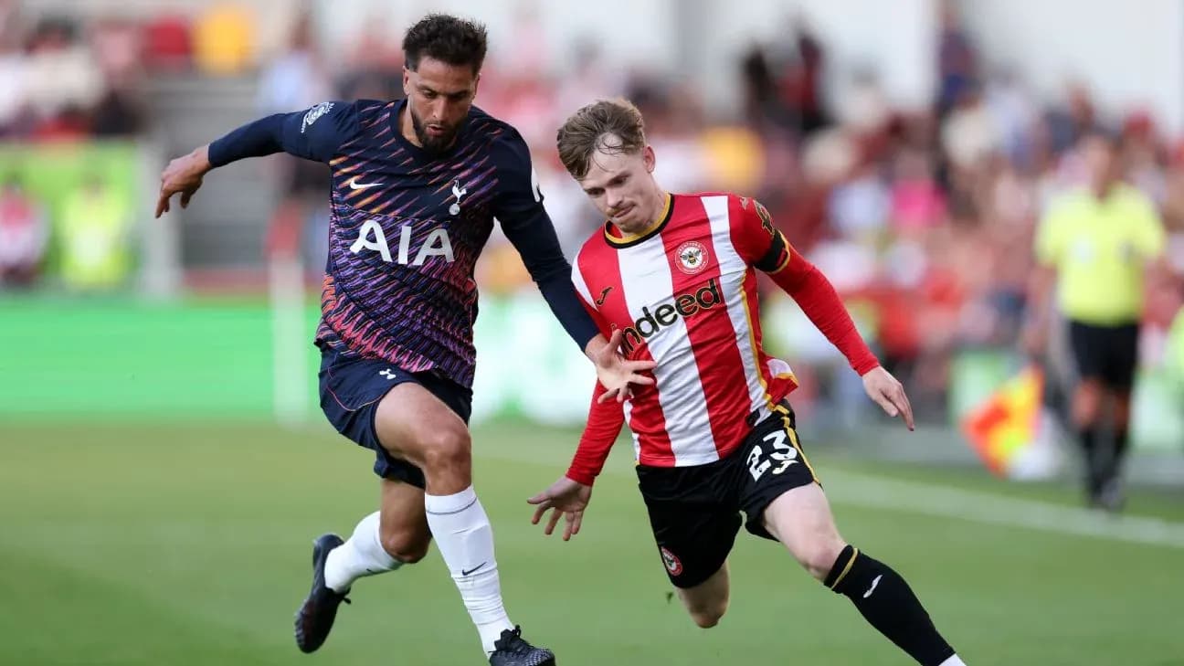 Brentford player challenging Tottenham opponent for the ball Brentford player challenging Tottenham opponent for the ball
