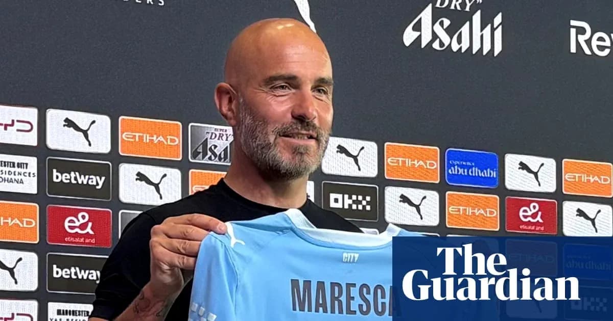 Manager holding new jersey at press conference Manager holding new jersey at press conference