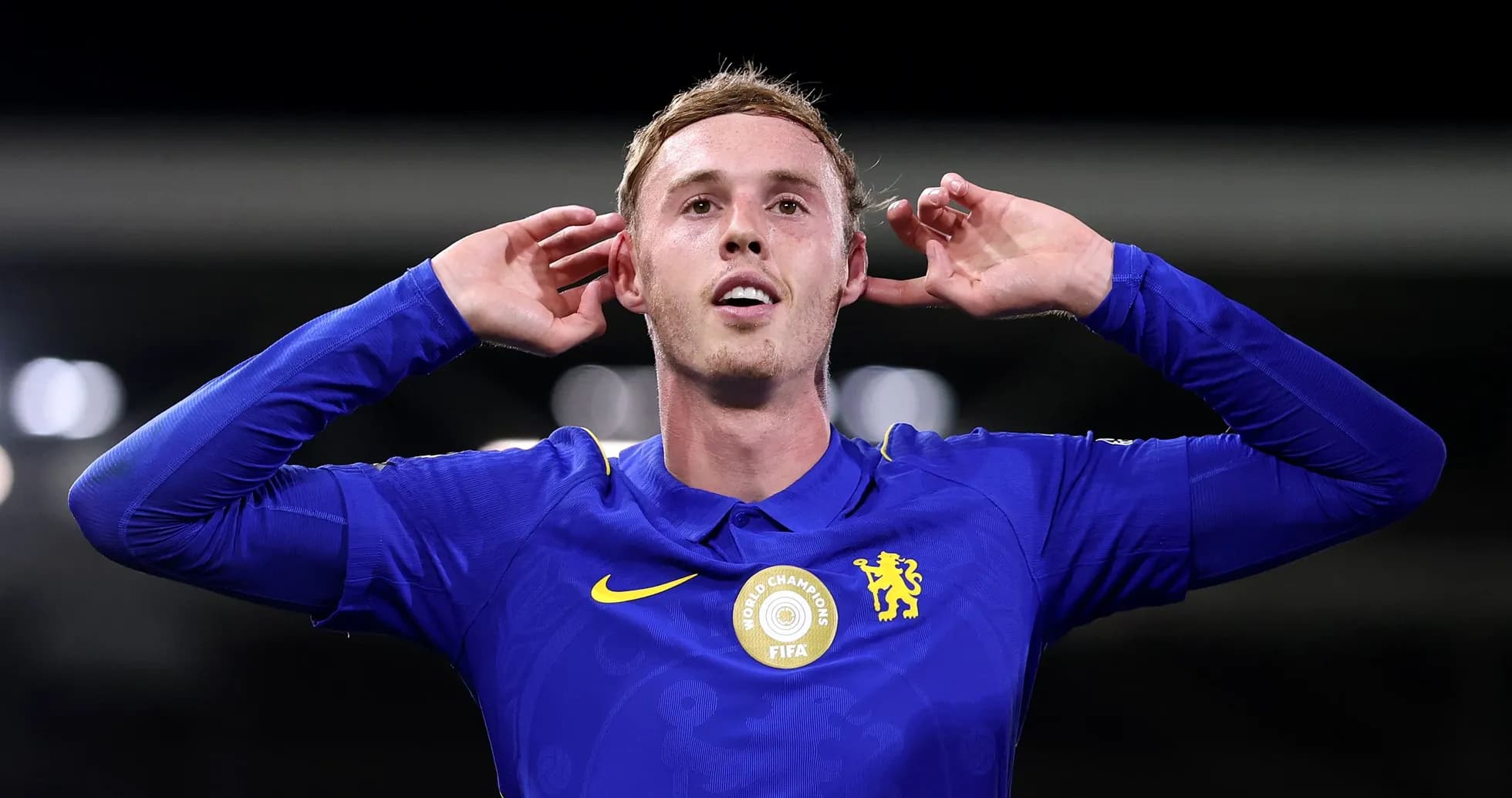 Player celebrating with hands behind ears in blue jersey Player celebrating with hands behind ears in blue jersey