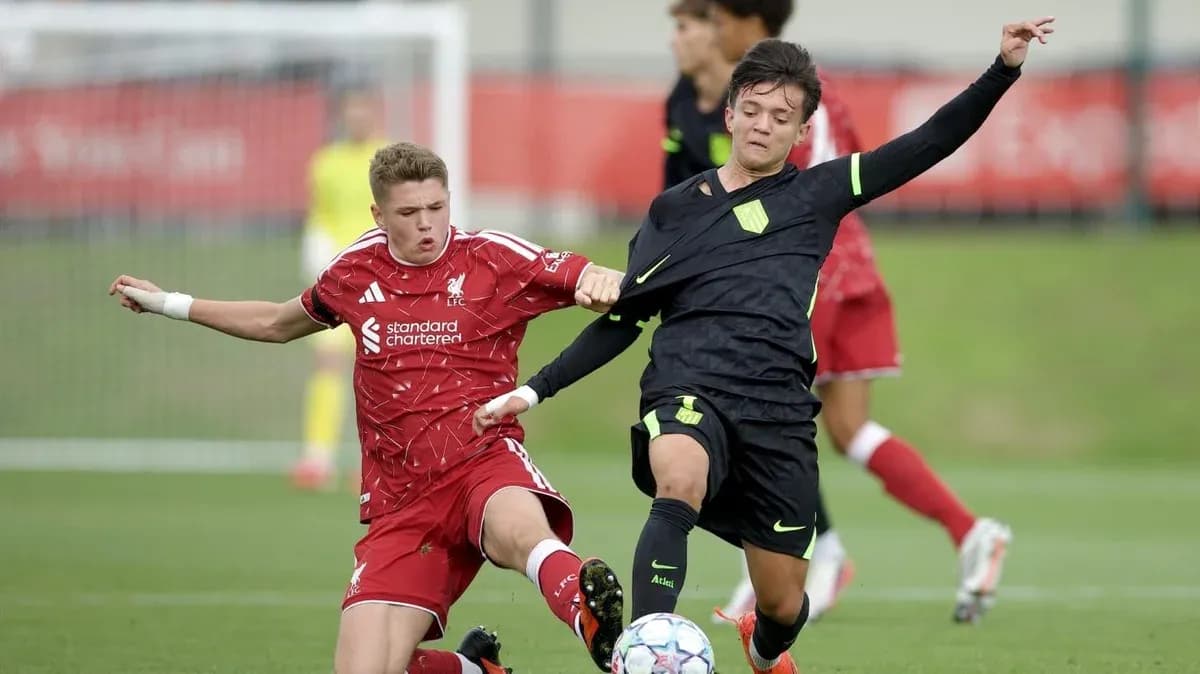 Two players competing for the ball in match Two players competing for the ball in match