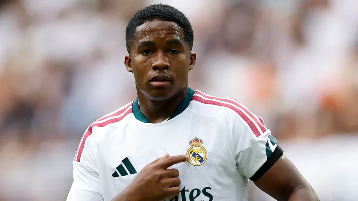 Player pointing to Real Madrid badge on jersey Player pointing to Real Madrid badge on jersey