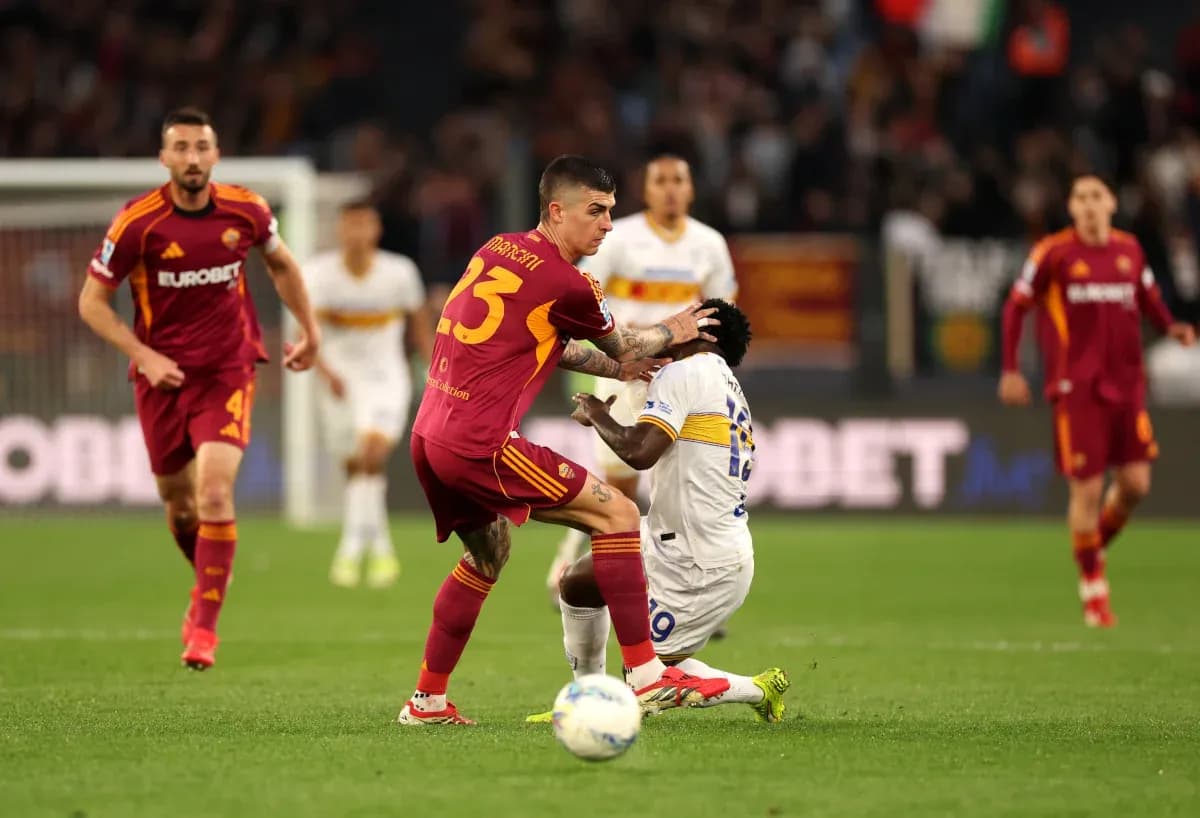 AS Roma player tackling Lecce player during match AS Roma player tackling Lecce player during match