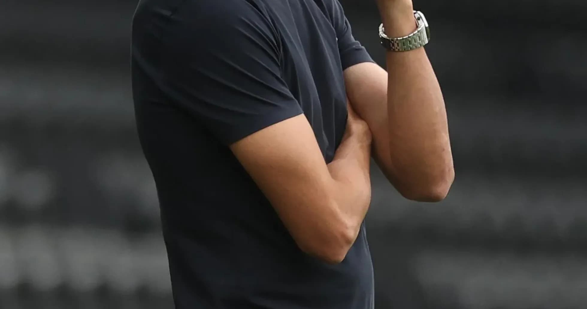 Coach observing the game with arms crossed Coach observing the game with arms crossed