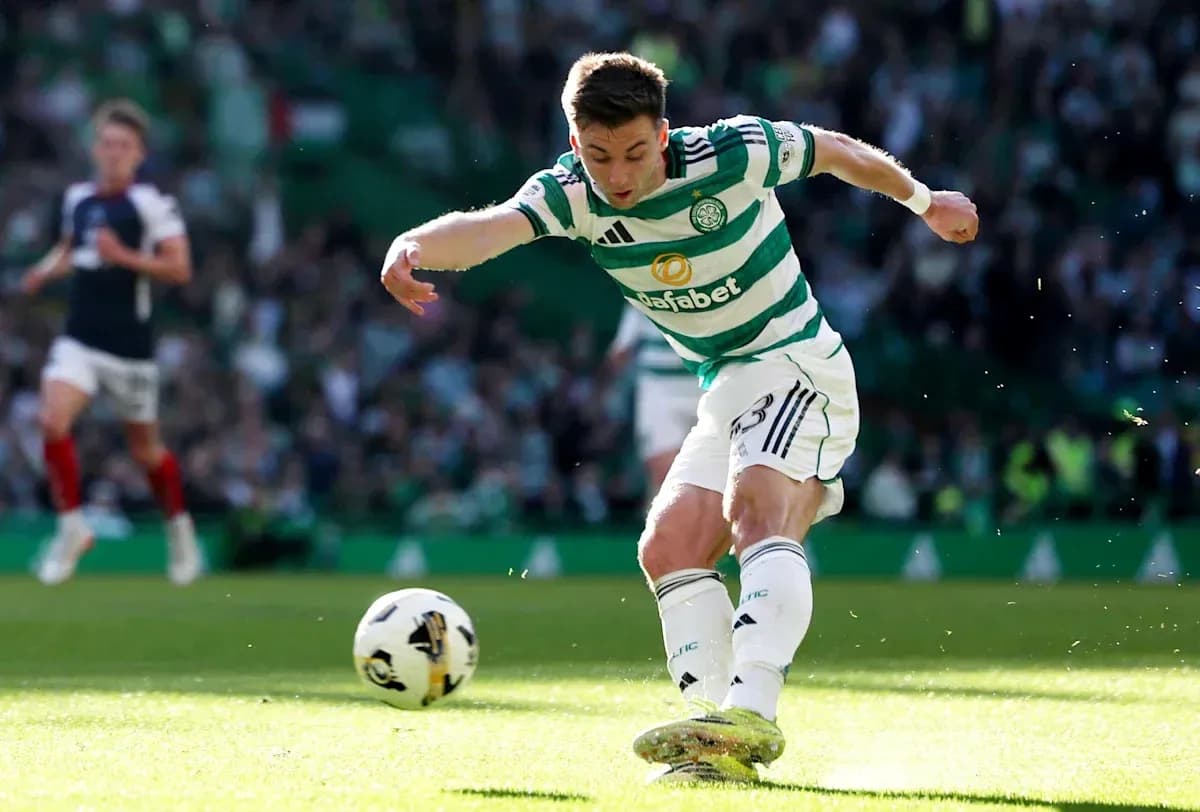 Player kicking ball during match at Celtic Park Player kicking ball during match at Celtic Park