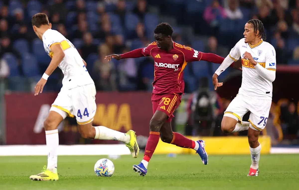 Player in red dribbling past two defenders during match Player in red dribbling past two defenders during match