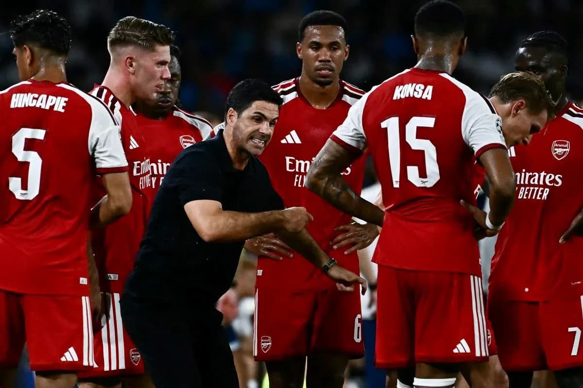 Arsenal coach instructing players during a team huddle Arsenal coach instructing players during a team huddle
