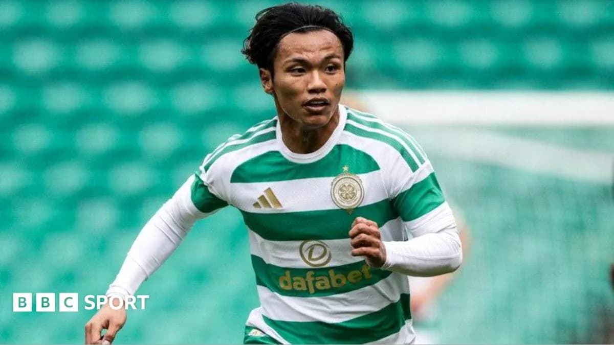 Player running during a match wearing Celtic jersey Player running during a match wearing Celtic jersey