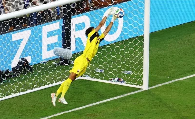 Goalkeeper diving to save a penalty kick Goalkeeper diving to save a penalty kick