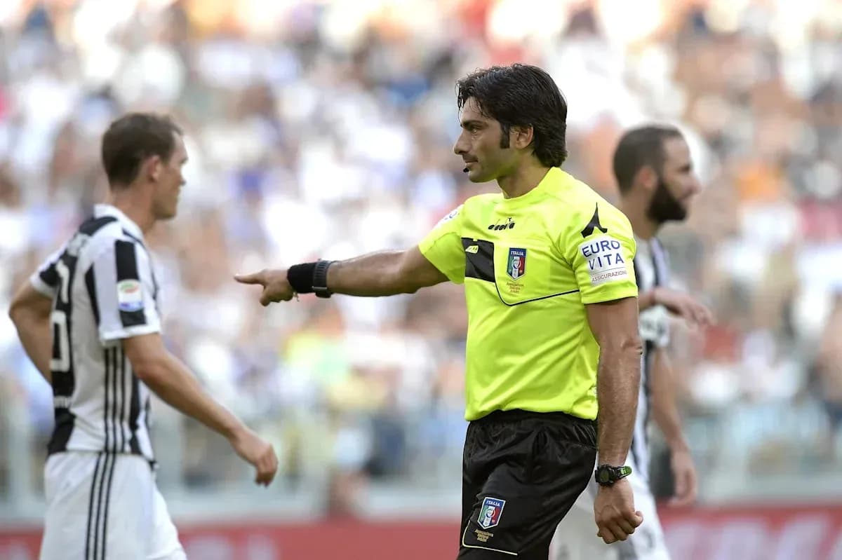 Referee gesturing to player during a match Referee gesturing to player during a match