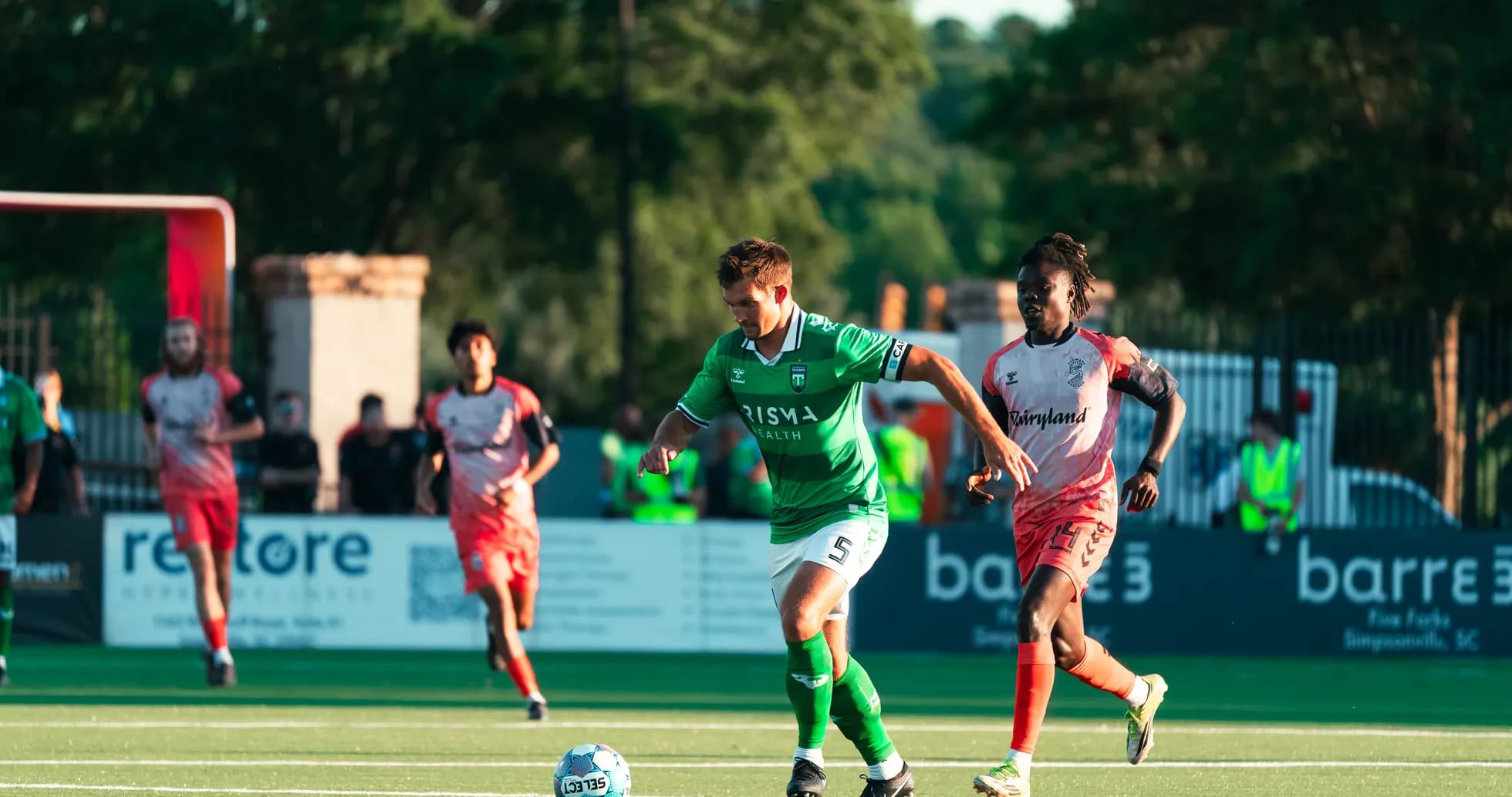 Player dribbling the ball during match action Player dribbling the ball during match action