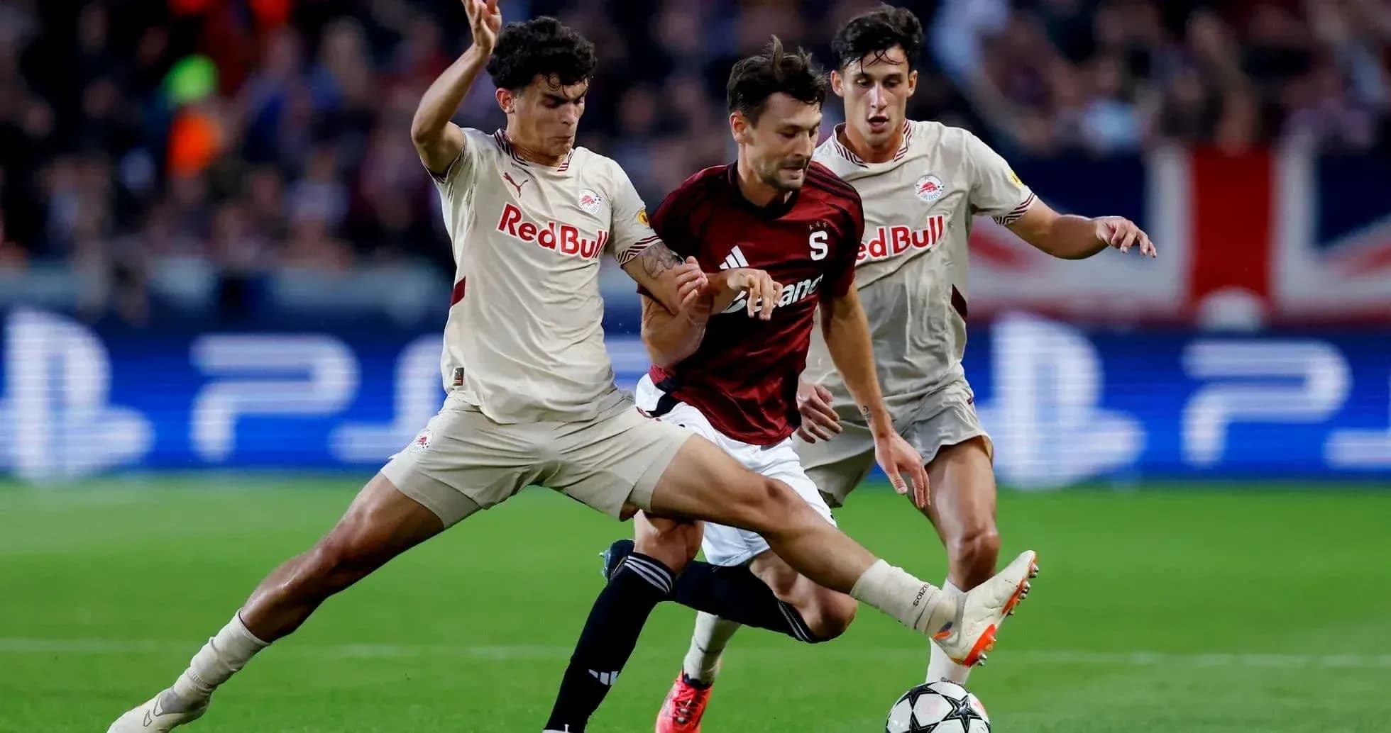 Players contesting for the ball in UEFA match Players contesting for the ball in UEFA match