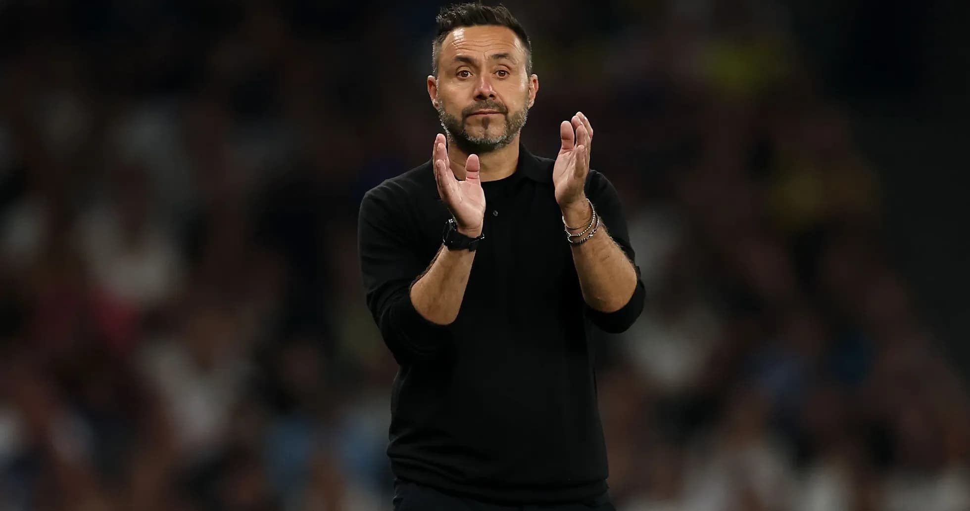 Coach clapping during a football match Coach clapping during a football match