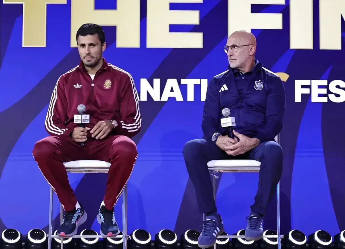 Two coaches seated at press conference with microphones Two coaches seated at press conference with microphones
