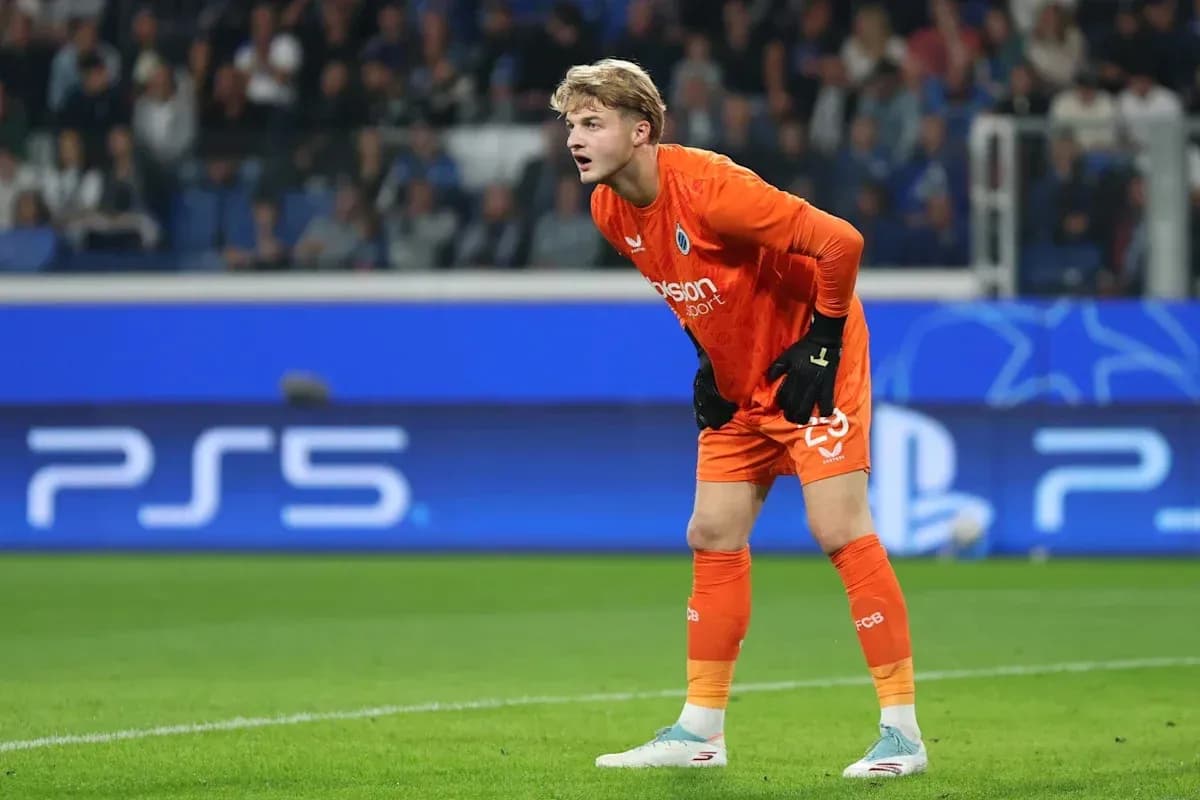 Goalkeeper in orange kit during a match Goalkeeper in orange kit during a match