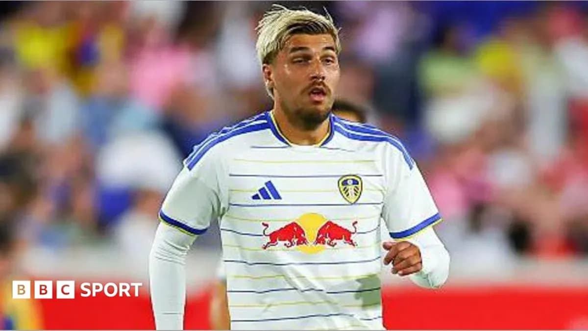 Player in Leeds United kit running on field Player in Leeds United kit running on field